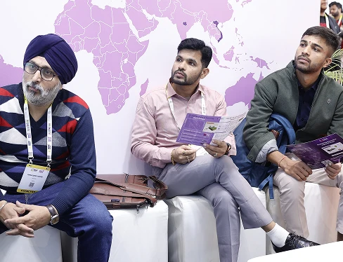 Wide shot of COLTEC booth showing demo zone and branding backdrop