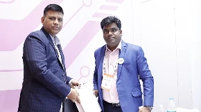 Wide shot of COLTEC booth during partner interactions and meetings