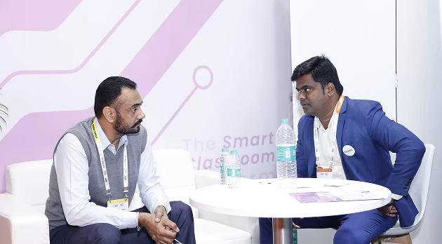 COLTEC representative in discussion with reseller at DIDAC booth