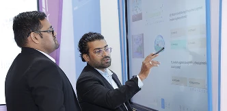 Educator annotating over lesson material on COLTEC display