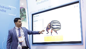 Presenter explaining Qeeb dashboard on COLTEC panel to attendees