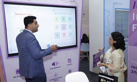 Teacher writing on COLTEC interactive panel during hands-on session