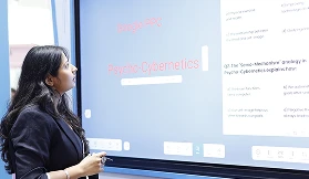 Corporate visitors in discussion near COLTEC demo zone